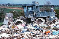 Tractor helping deal with waste in a landfill site